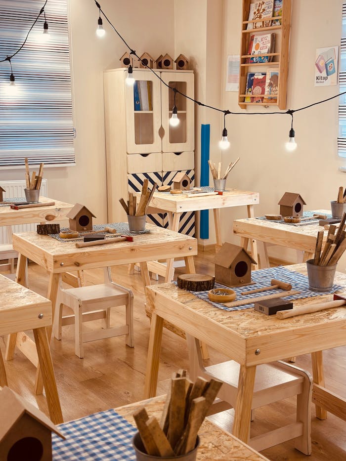 Inviting classroom setup featuring craft tables, birdhouses, and warm lighting, perfect for imaginative children's activities.